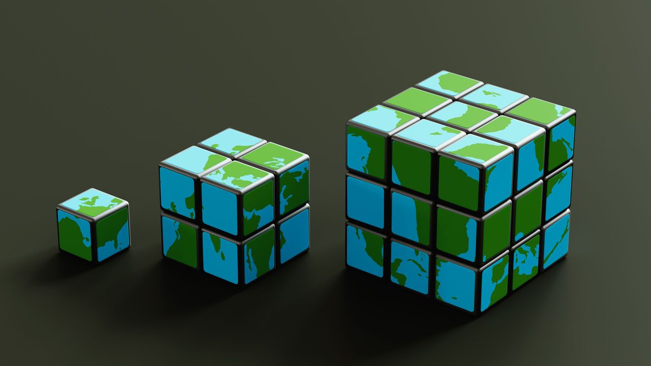 illustration of three rubik's cubes, depicting different areas of the world