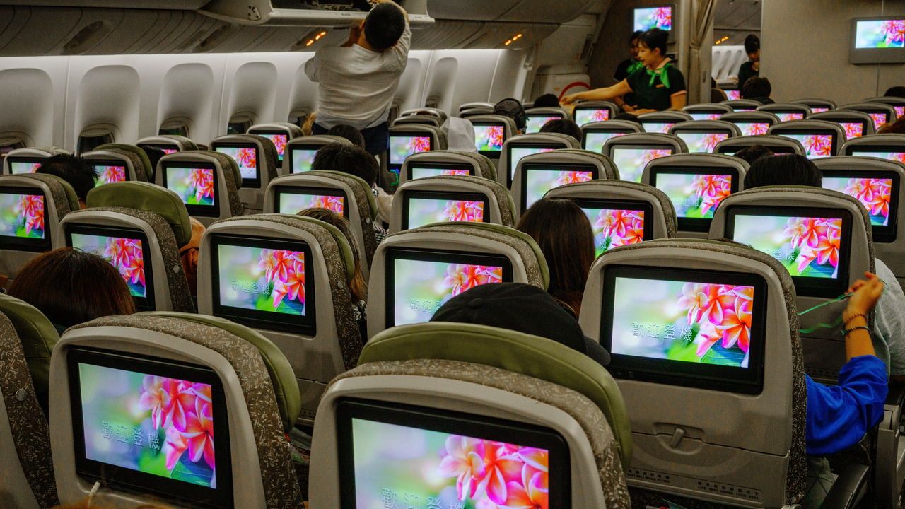 TVs on seat backs in a plane.