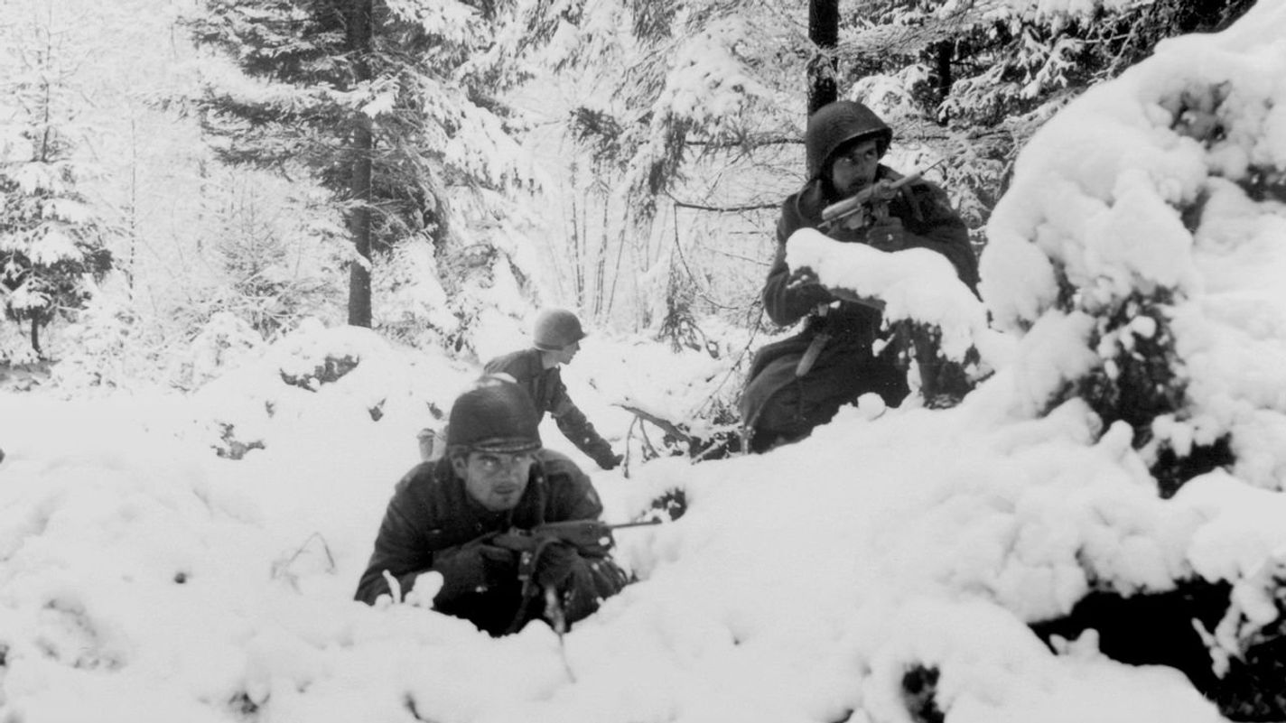 American infantrymen of the 290th Regiment of the US Army fight in fresh snowfall near Amonines, Belgium. The fighting and German counter-offensive on the Belgian-German border later became famous as the Battle of the Bulge