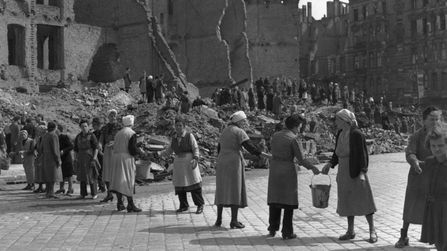 9th July 1945: Women in post-war Berlin, East Germany, form a 'chain gang' to pass pails of rubble to a rubble dump, to clear bombed areas in the Russian sector of the city. (Photo by Fred Ramage/Keystone/Getty Images)