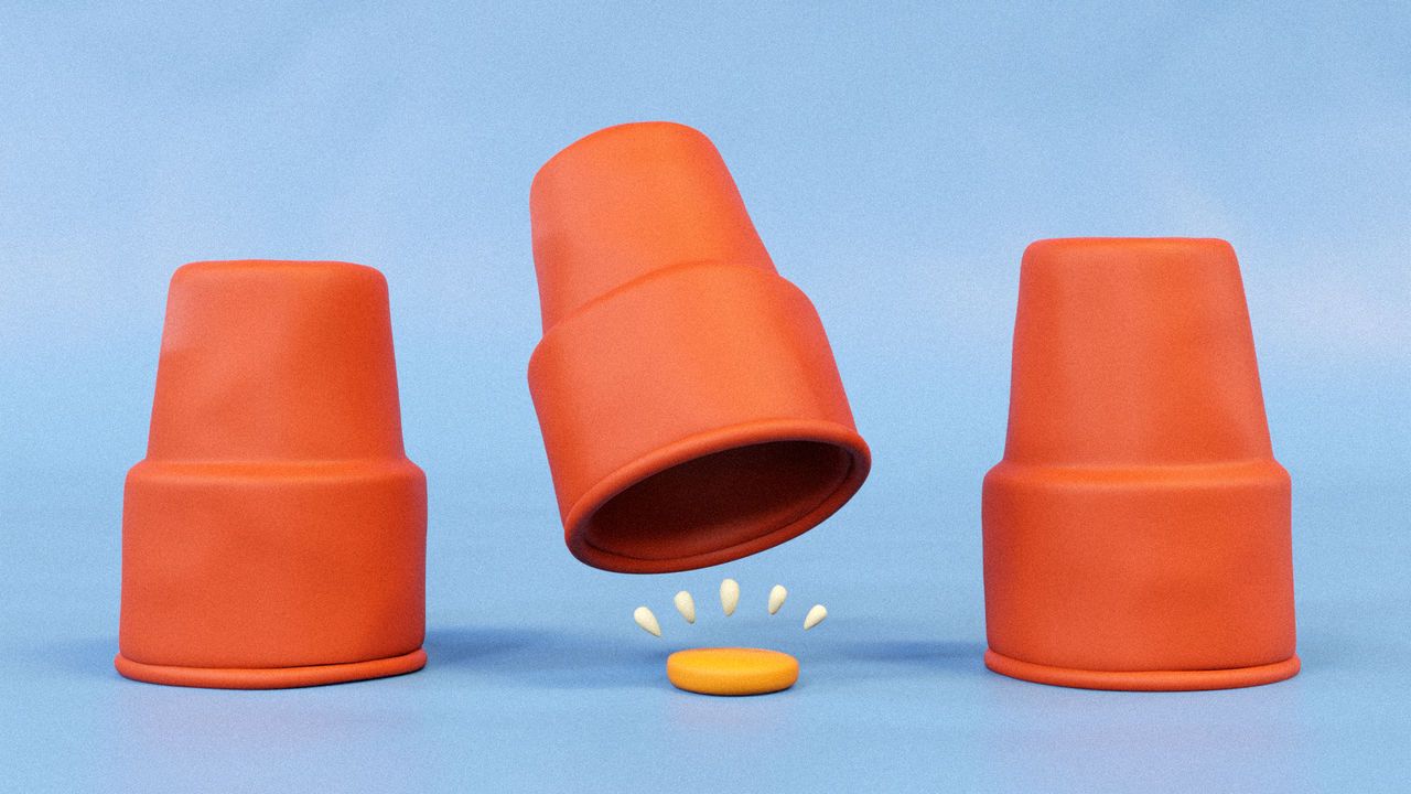 An illustration of three red cups in a row. The cup in the centre is lifted to reveal a coin beneath.