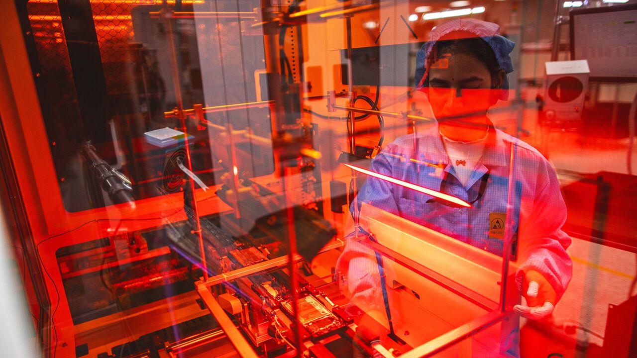 Employees work on a mobile phone assembly line at Padget Electronics Pvt., a subsidiary of Dixon Technologies Ltd., in Noida, India.
