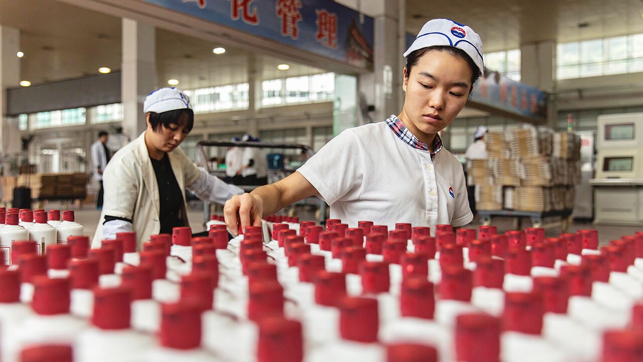 Employees work on the bottling line at the Kweichow Moutai factory in Moutai, China