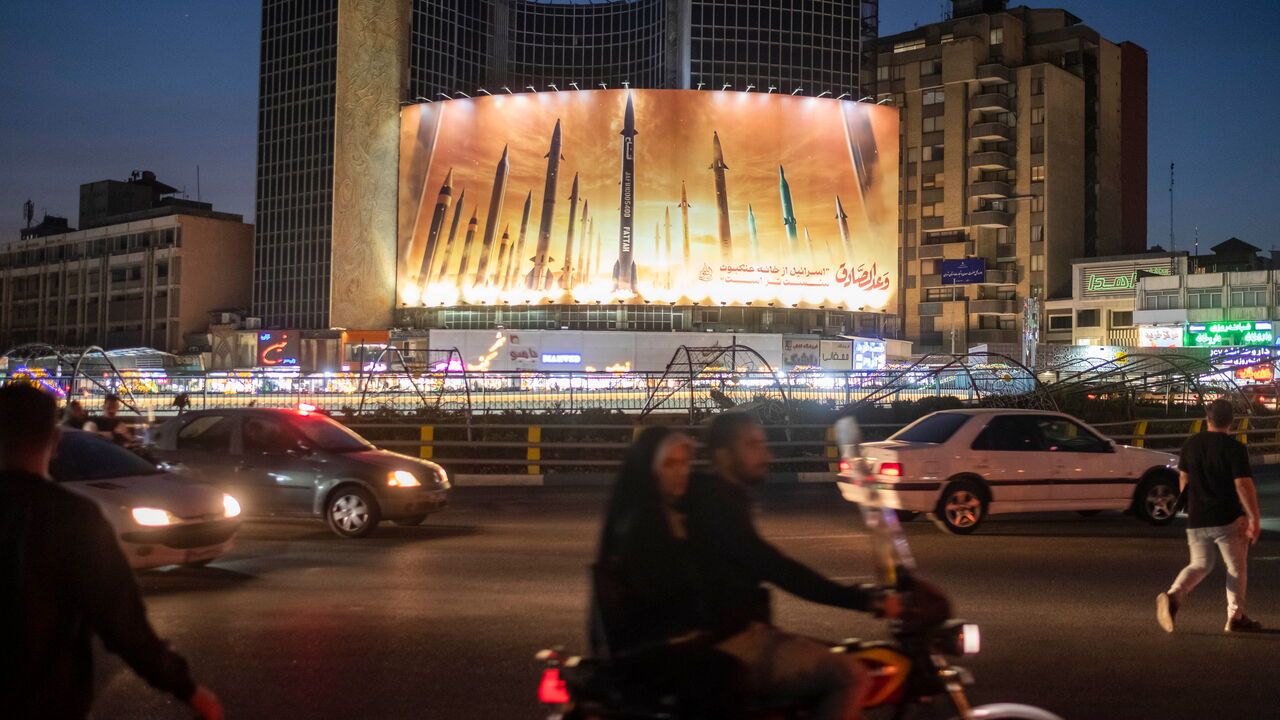 A billboard is displaying an image of the Islamic Revolutionary Guards' missiles being launched against Israel, hanging on a governmental building in downtown Tehran, Iran