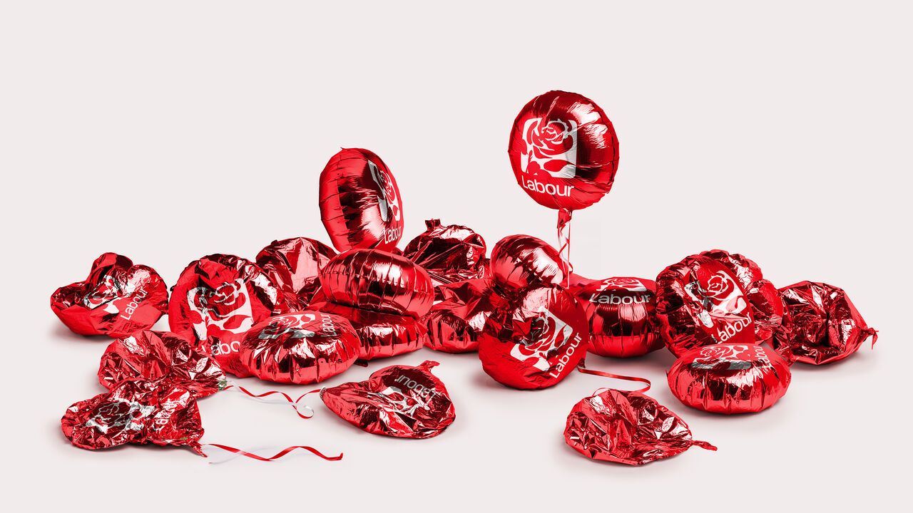 An illustration of a pile of mostly deflated red balloons with the Labour party logo on them.
