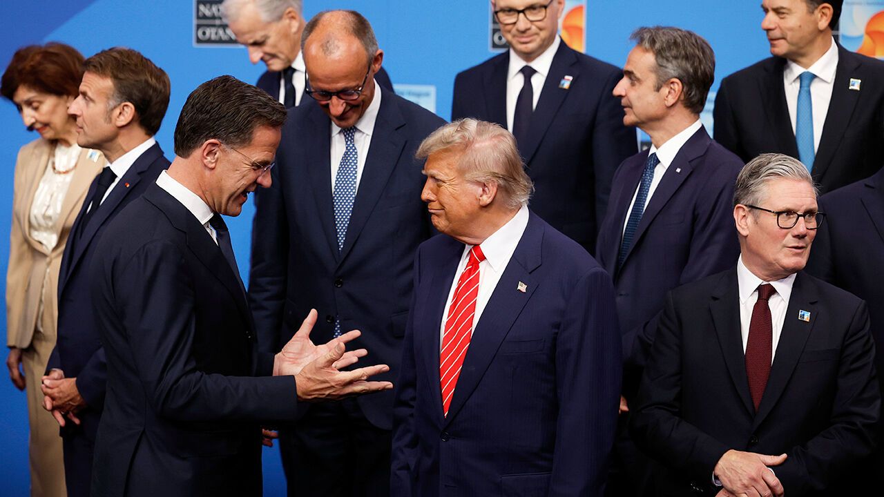 President Donald Trump, center, speaks with NATO Secretary General Mark Rutte during a family photo