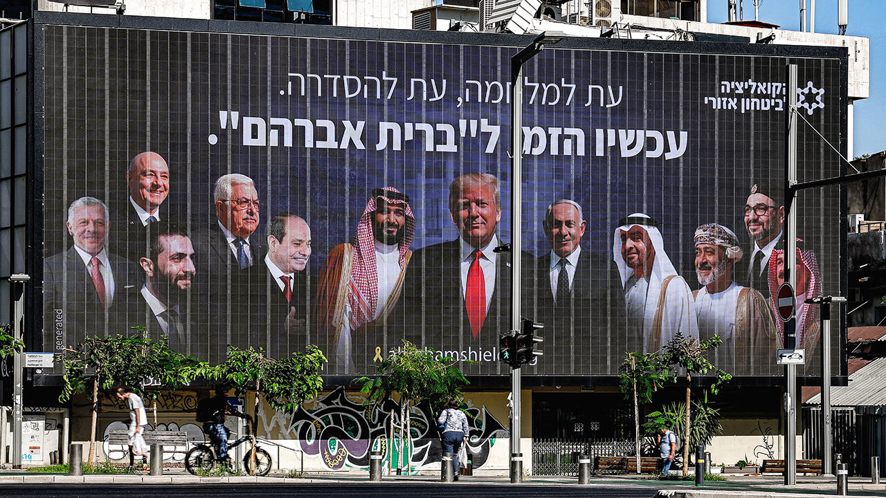 A billboard with the Hebrew slogan "a time for war, a time for settlement; now is the time for the 'Abrahamic Covenant'" is displayed in Tel Aviv on June 26, 2025