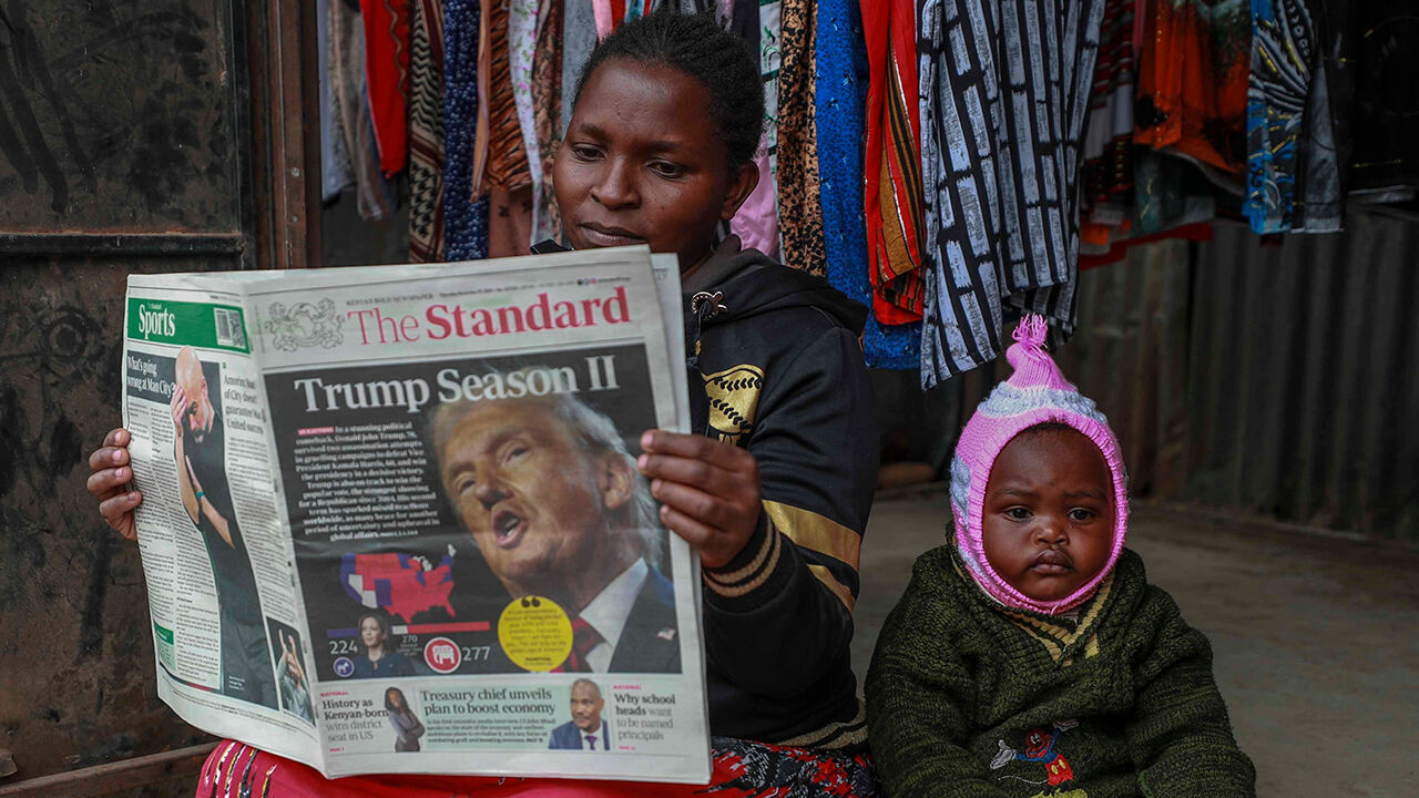 A Kenyan reads a morning newspaper with reports on the U.S. election on front page