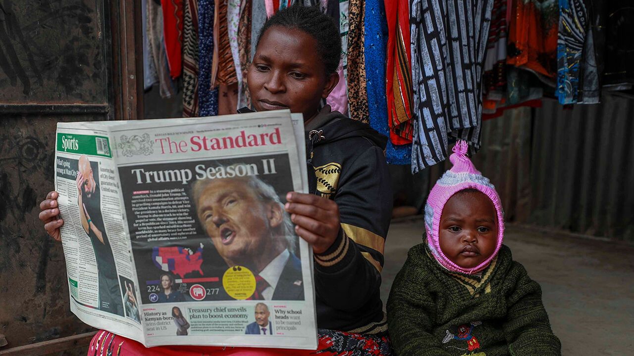 A Kenyan reads a morning newspaper with reports on the U.S. election on front page