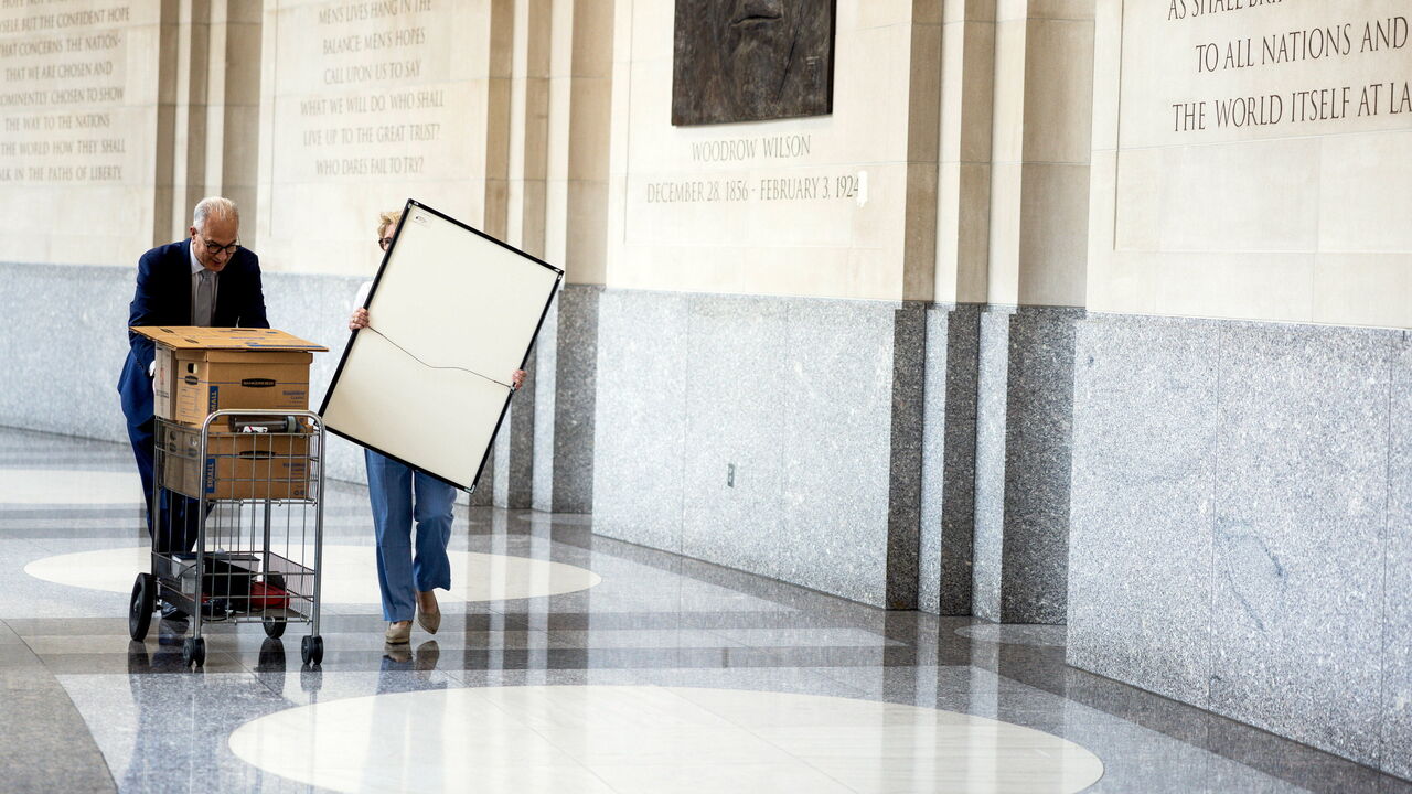 Fired workers leave the Wilson Center, one of the many independent agencies targeted for takeover or elimination 